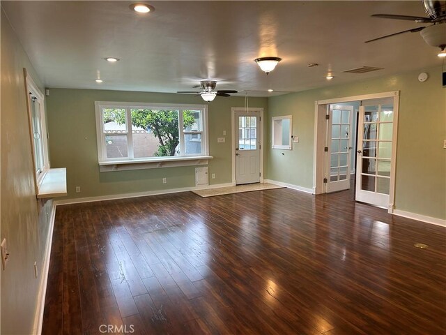 unfurnished living room featuring visible vents, ceiling fan, hardwood / wood-style floors, and baseboards