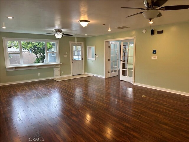 unfurnished living room featuring ceiling fan, visible vents, hardwood / wood-style floors, baseboards, and french doors