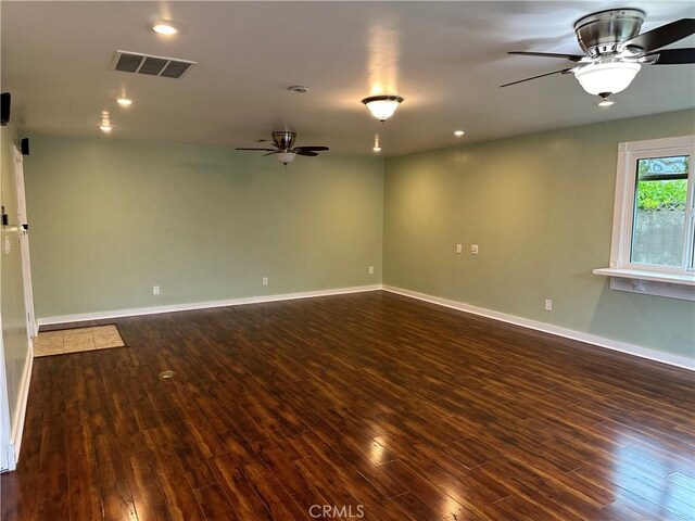 empty room with recessed lighting, dark wood-style flooring, baseboards, visible vents, and a ceiling fan