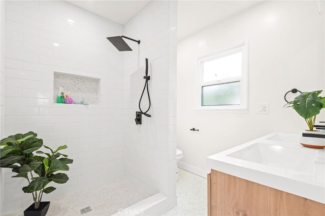 2430 Van Wick St, Inglewood, CA 90303 - full bathroom featuring vanity, toilet, a tile shower, baseboards, and speckled floor