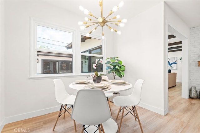 2430 Van Wick St, Inglewood, CA 90303 - dining room featuring an inviting chandelier, wood finished floors, and baseboards