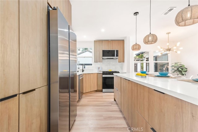 2430 Van Wick St, Inglewood, CA 90303 - kitchen with modern cabinets, light brown cabinets, appliances with stainless steel finishes, and visible vents