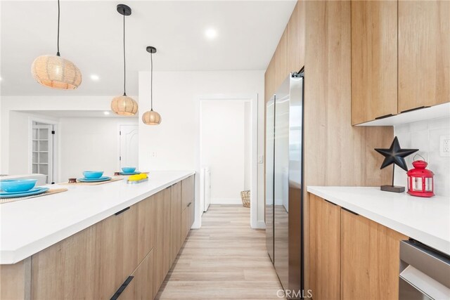 2430 Van Wick St, Inglewood, CA 90303 - kitchen with modern cabinets, light brown cabinets, light wood-style floors, light countertops, and freestanding refrigerator