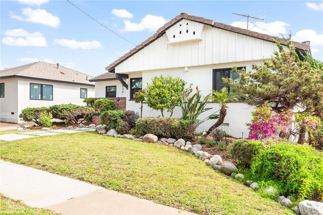 2430 Van Wick St, Inglewood, CA 90303 - bungalow-style house with a front lawn, a tile roof, and stucco siding