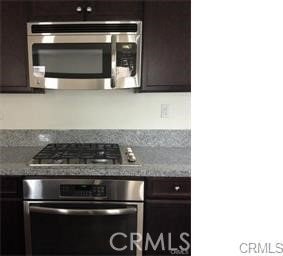 7076 Luminaire Ct, Eastvale, CA 92880 - kitchen featuring stainless steel appliances and dark brown cabinetry