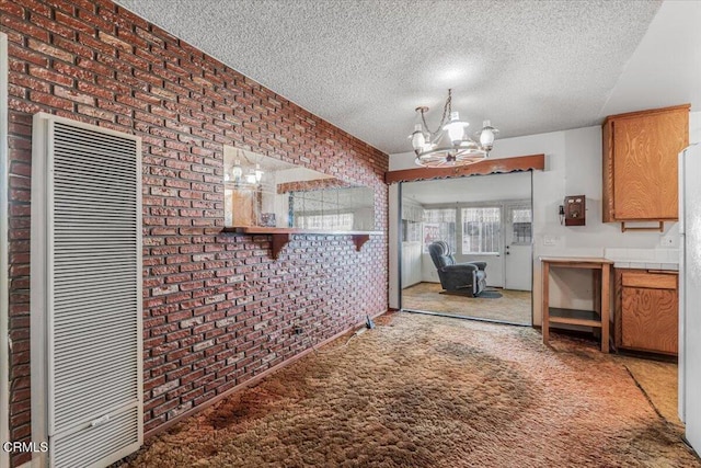 421 Andrea Dr, Oxnard, CA 93033 - unfurnished dining area with a heating unit, a textured ceiling, and brick wall