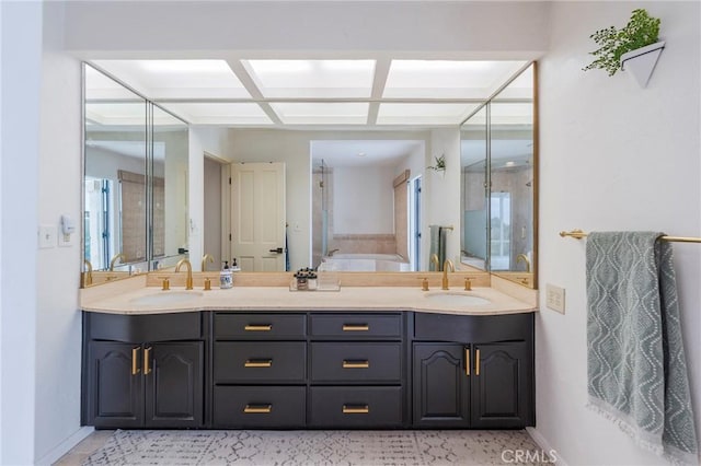 full bathroom featuring a sink, baseboards, and double vanity