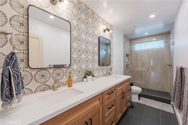 full bath featuring a sink, tile patterned flooring, a stall shower, and double vanity