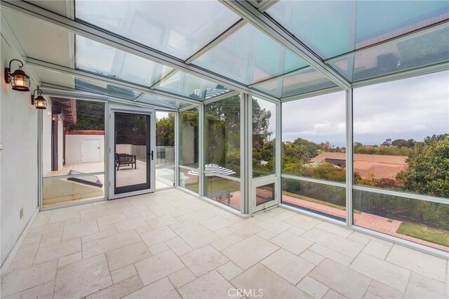 unfurnished sunroom featuring a wealth of natural light