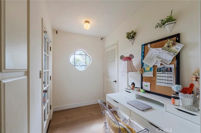 office area featuring baseboards and light wood-style floors