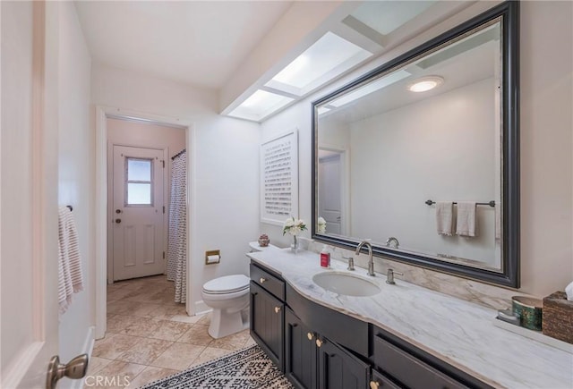 full bath with vanity, tile patterned flooring, toilet, baseboards, and a shower with shower curtain