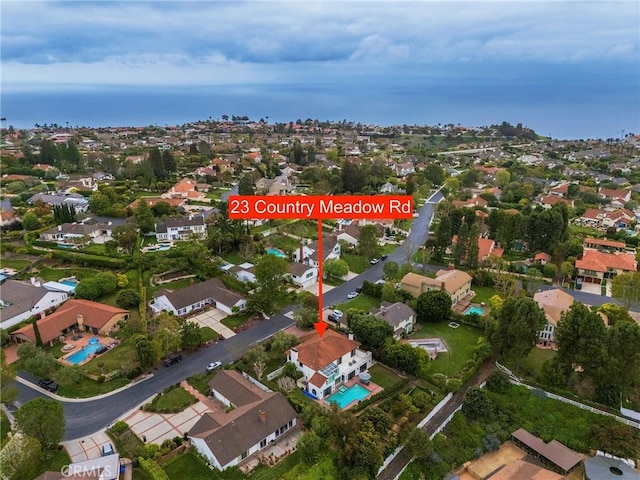 birds eye view of property featuring a residential view and a water view