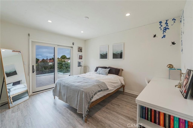 bedroom with light wood-style floors, recessed lighting, baseboards, and access to exterior