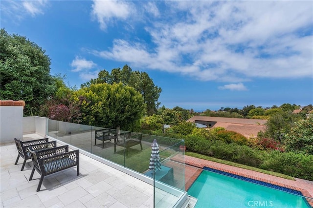 view of swimming pool featuring a patio and a fenced in pool