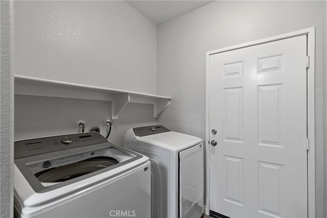 laundry area with separate washer and dryer and laundry area