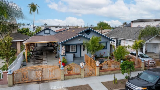 1843 Cerritos Ave, Long Beach, CA 90806 - bungalow-style home with a porch, a gate, a fenced front yard, driveway, and stucco siding