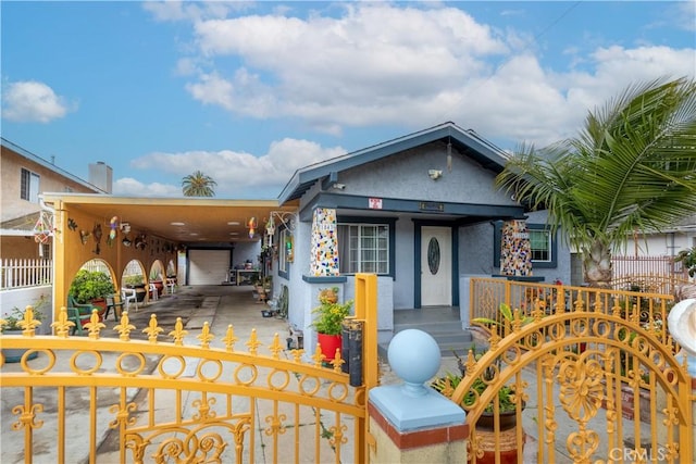 1843 Cerritos Ave, Long Beach, CA 90806 - view of front facade with a fenced front yard, a porch, a gate, and stucco siding