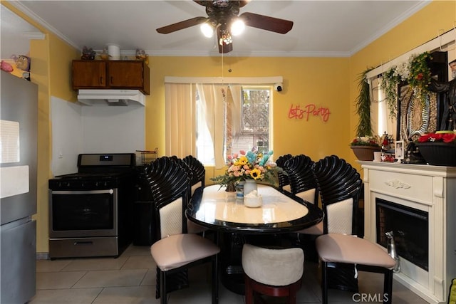 1843 Cerritos Ave, Long Beach, CA 90806 - dining space featuring ceiling fan, crown molding, light tile patterned floors, and a fireplace