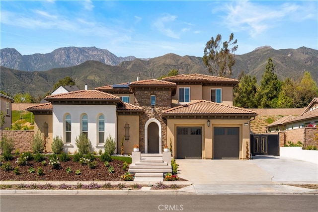 8826 Justify Dr, Rancho Cucamonga, CA 91701 - mediterranean / spanish-style home featuring stucco siding, a garage, stone siding, and concrete driveway