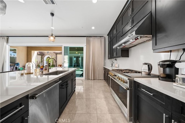 8826 Justify Dr, Rancho Cucamonga, CA 91701 - kitchen with appliances with stainless steel finishes, a sink, dark cabinets, under cabinet range hood, and light countertops