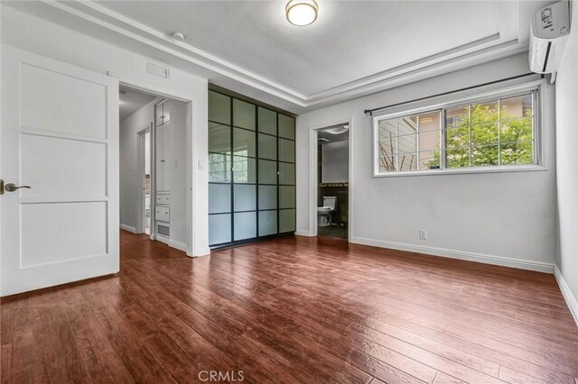 interior space with hardwood / wood-style flooring, a wealth of natural light, visible vents, and baseboards