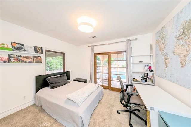 bedroom with visible vents, access to exterior, and light colored carpet