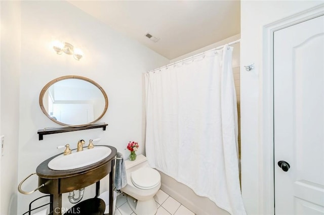 full bathroom with visible vents, tile patterned flooring, shower / bath combo with shower curtain, toilet, and a sink