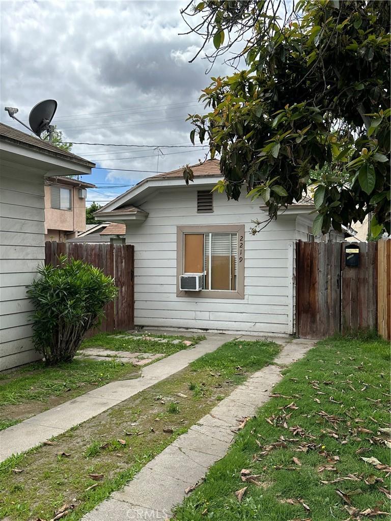view of home's exterior with fence, a yard, and cooling unit