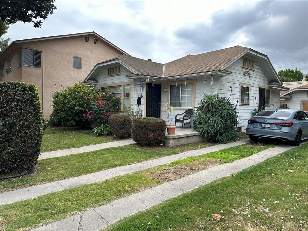 bungalow-style house featuring a porch and a front yard