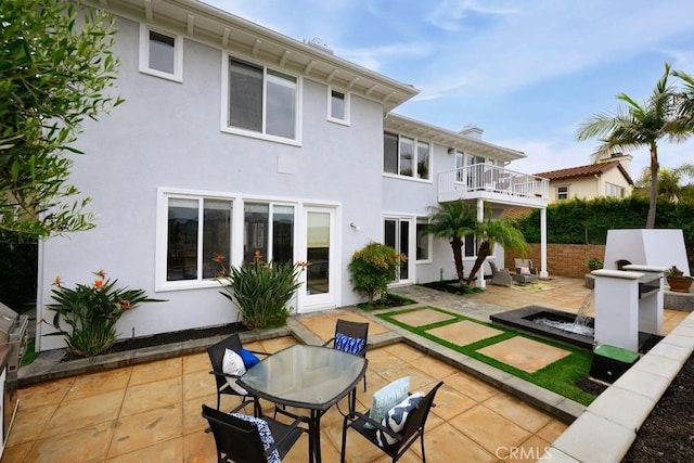 4505 Cresta Babia, San Clemente, CA 92673 - rear view of house featuring stucco siding, a balcony, a patio, and outdoor dining area