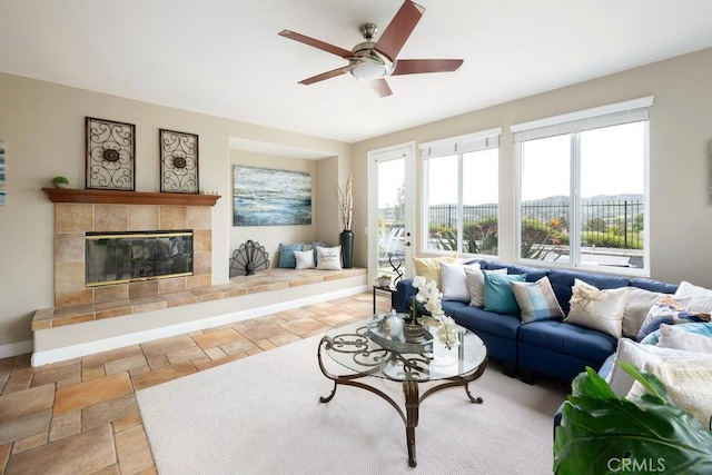 4505 Cresta Babia, San Clemente, CA 92673 - living area featuring a ceiling fan, a tile fireplace, and stone finish flooring