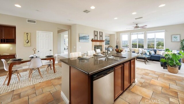 4505 Cresta Babia, San Clemente, CA 92673 - kitchen featuring dishwasher, dark stone counters, open floor plan, a center island with sink, and recessed lighting
