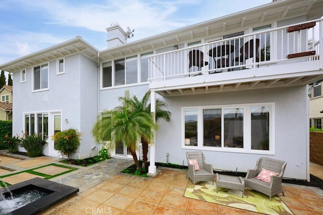 4505 Cresta Babia, San Clemente, CA 92673 - back of house featuring a balcony, a patio, stucco siding, and a chimney