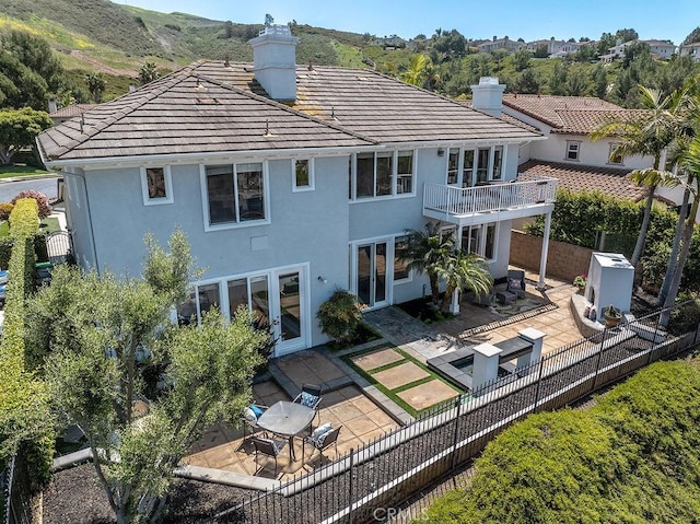4505 Cresta Babia, San Clemente, CA 92673 - rear view of property featuring a chimney, stucco siding, a fenced backyard, a balcony, and a patio