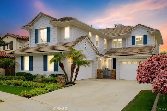 4505 Cresta Babia, San Clemente, CA 92673 - view of front of house featuring a tiled roof, a garage, and driveway