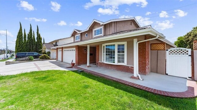 16001 Ballantine Ln, Huntington Beach, CA 92647 - view of front of property with an attached garage, concrete driveway, covered porch, board and batten siding, and brick siding