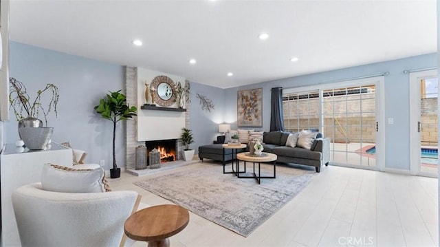 16001 Ballantine Ln, Huntington Beach, CA 92647 - living area with a lit fireplace, recessed lighting, and wood finished floors