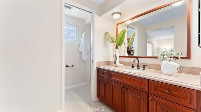 16001 Ballantine Ln, Huntington Beach, CA 92647 - bathroom featuring vanity and baseboards