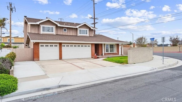 16001 Ballantine Ln, Huntington Beach, CA 92647 - traditional-style house featuring brick siding, driveway, board and batten siding, and an attached garage