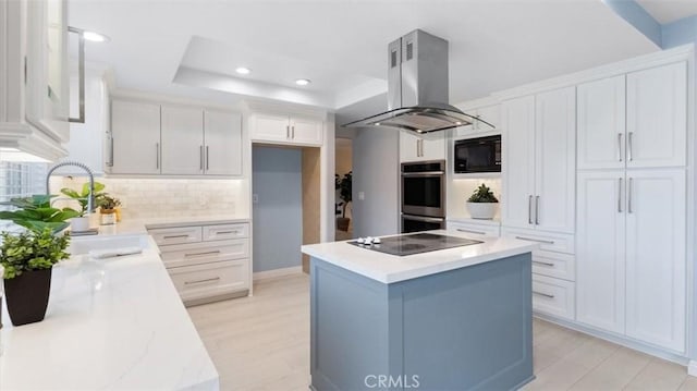 16001 Ballantine Ln, Huntington Beach, CA 92647 - kitchen featuring island range hood, black appliances, white cabinets, a center island, and backsplash