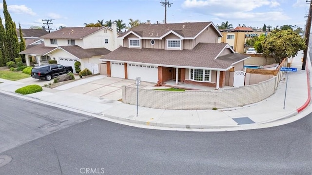 16001 Ballantine Ln, Huntington Beach, CA 92647 - traditional home featuring a fenced front yard, concrete driveway, a residential view, and an attached garage