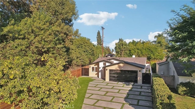 exterior space with fence and concrete driveway