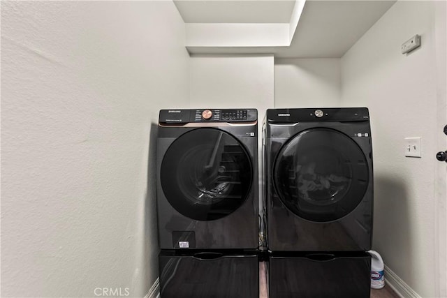 11415 216th St Unit 24, Lakewood, CA 90715 - clothes washing area featuring baseboards, wood finished floors, washer and clothes dryer, and laundry area