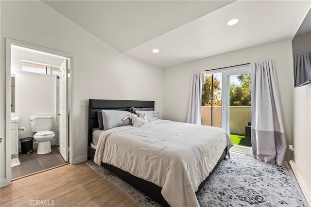 11415 216th St Unit 24, Lakewood, CA 90715 - bedroom with access to exterior, baseboards, lofted ceiling, wood finished floors, and ensuite bath