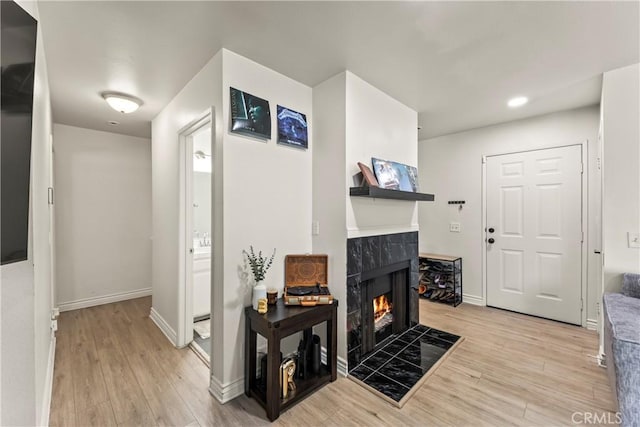 11415 216th St Unit 24, Lakewood, CA 90715 - living area with a tiled fireplace, baseboards, recessed lighting, and light wood-type flooring