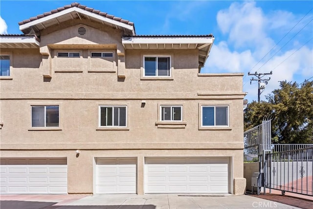 11415 216th St Unit 24, Lakewood, CA 90715 - exterior space with concrete driveway, an attached garage, and fence