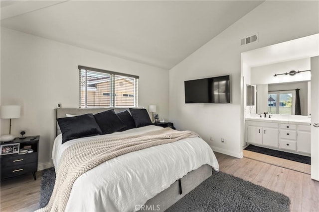 11415 216th St Unit 24, Lakewood, CA 90715 - bedroom featuring vaulted ceiling, a sink, light wood-style flooring, baseboards, and visible vents