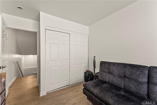 11415 216th St Unit 24, Lakewood, CA 90715 - sitting room featuring baseboards, visible vents, light wood-style floors, and an upstairs landing