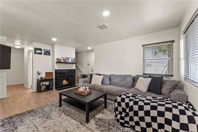 11415 216th St Unit 24, Lakewood, CA 90715 - living room featuring baseboards, visible vents, recessed lighting, light wood-style floors, and a fireplace