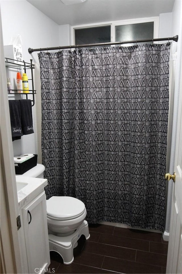 2653 Ashcroft Ave, Clovis, CA 93611 - bathroom with wood tiled floor, vanity, toilet, and tiled shower